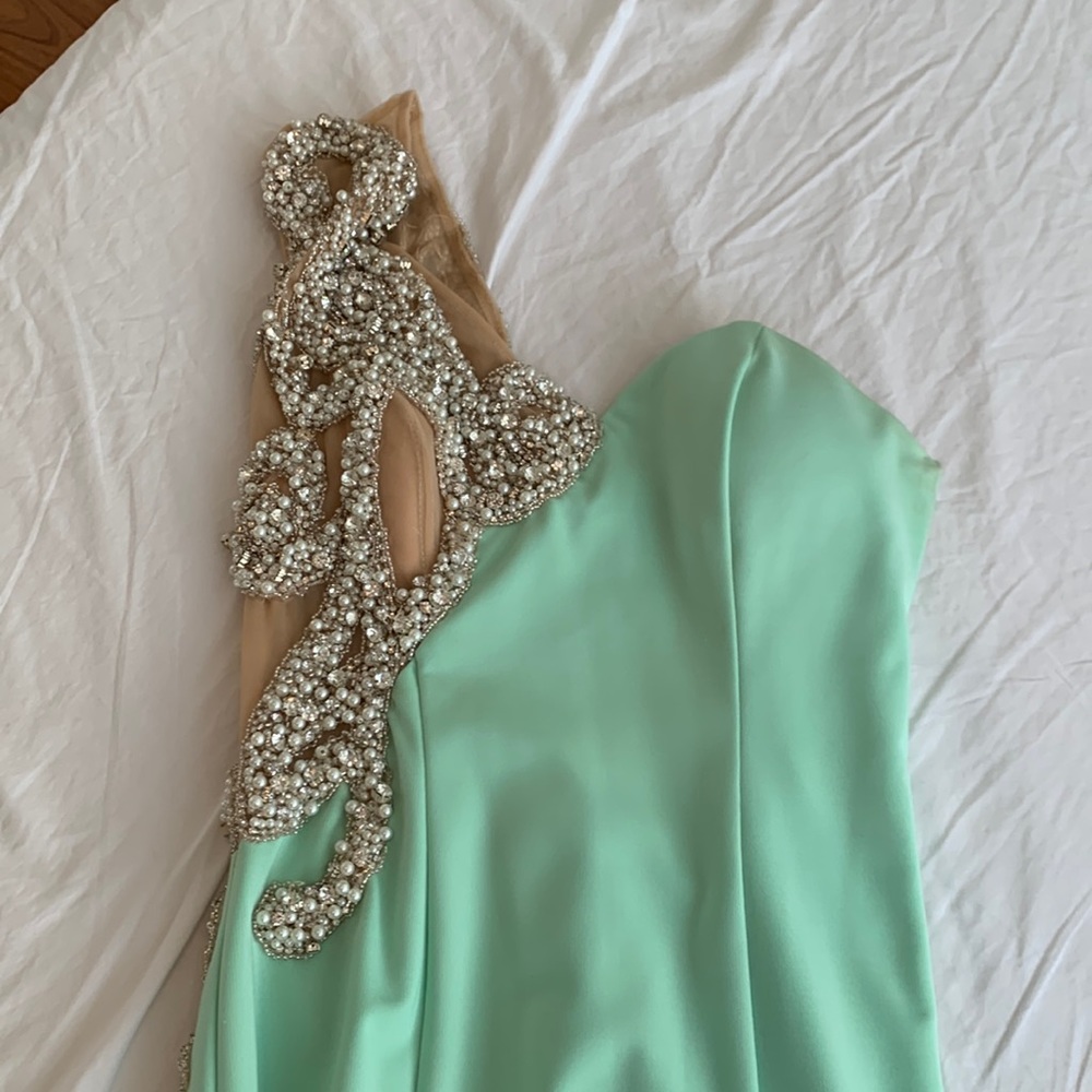 Long green one shoulder dress.